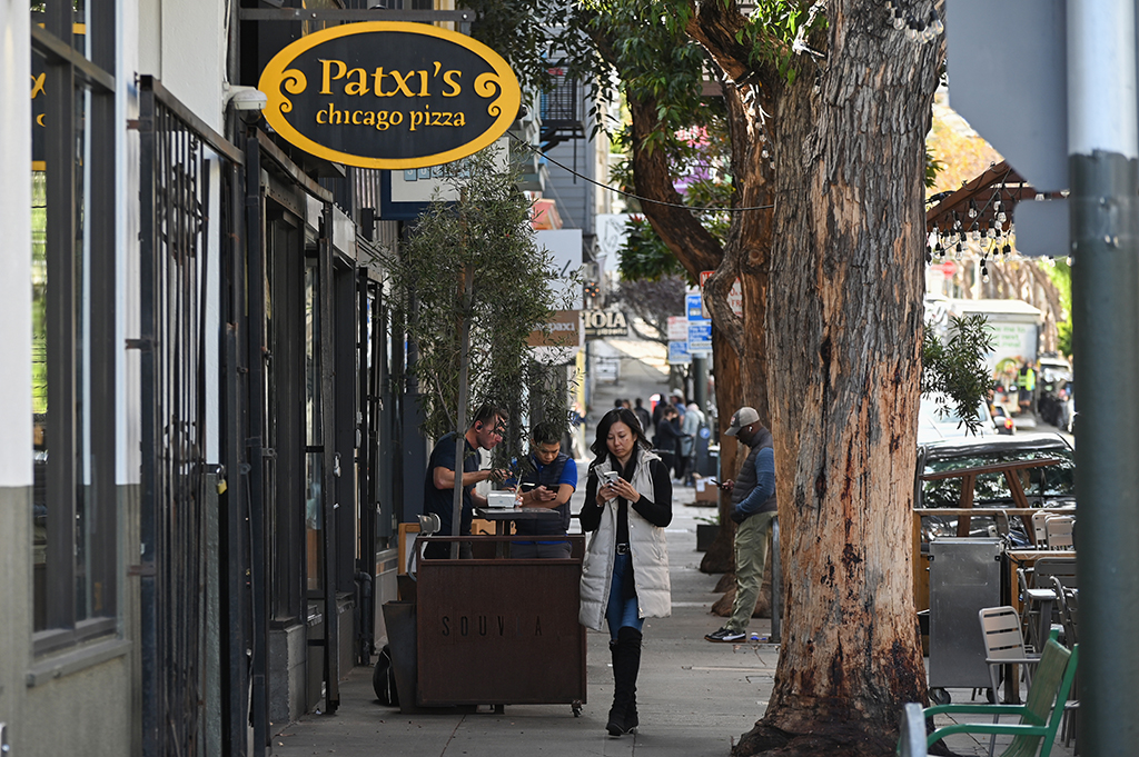 SAN FRANCISCO: Pedestrians walk along Hayes Street in the Hayes Valley neighborhood of an Francisco, California.— AFP