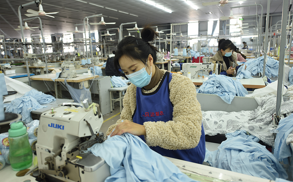 LIANYUNGANG, China: This photo taken on November 14, 2022 shows an employee producing clothing, which will be exported, at a factory in Lianyungang in China's eastern Jiangsu province. – AFP