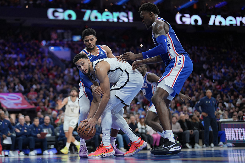 PHILADELPHIA: Ben Simmons #10 of the Brooklyn Nets controls the ball against Tobias Harris #12 and Paul Reed #44 of the Philadelphia 76ers in the fourth quarter of the game at the Wells Fargo Center on November 22, 2022.- AFP