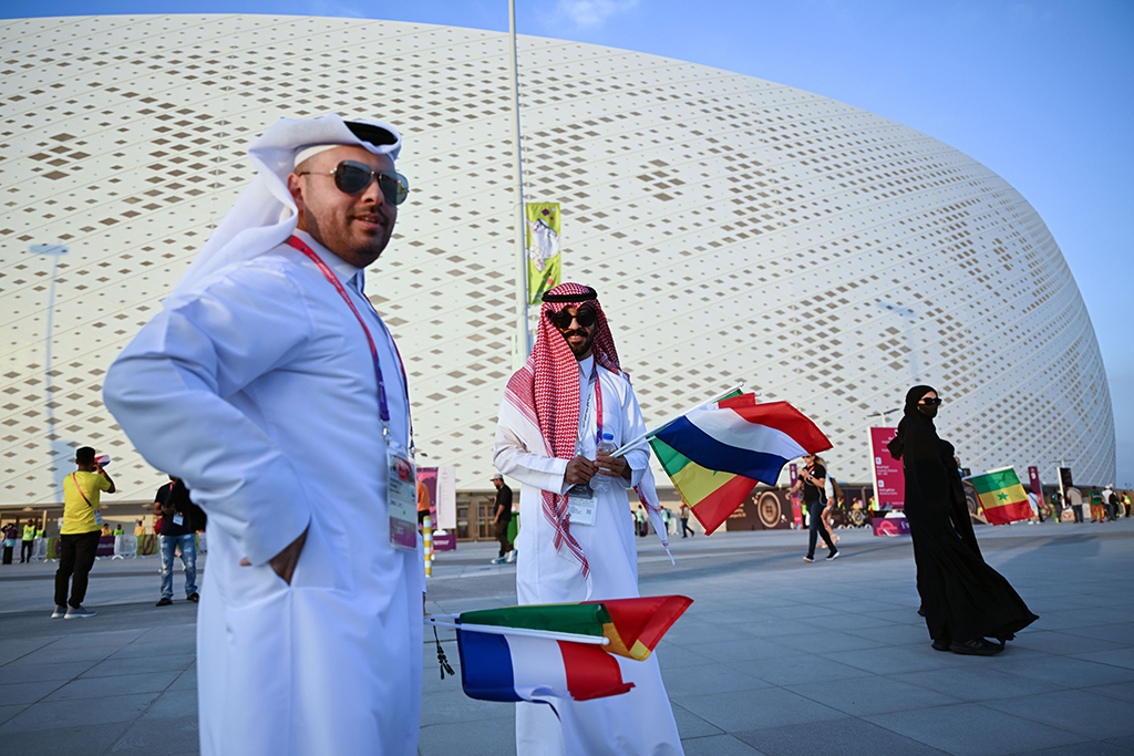 DOHA: People with flags arrive prior to the Qatar 2022 World Cup Group A football match between Senegal and the Netherlands at the Al-Thumama Stadium in Doha on November 21, 2022. - AFP