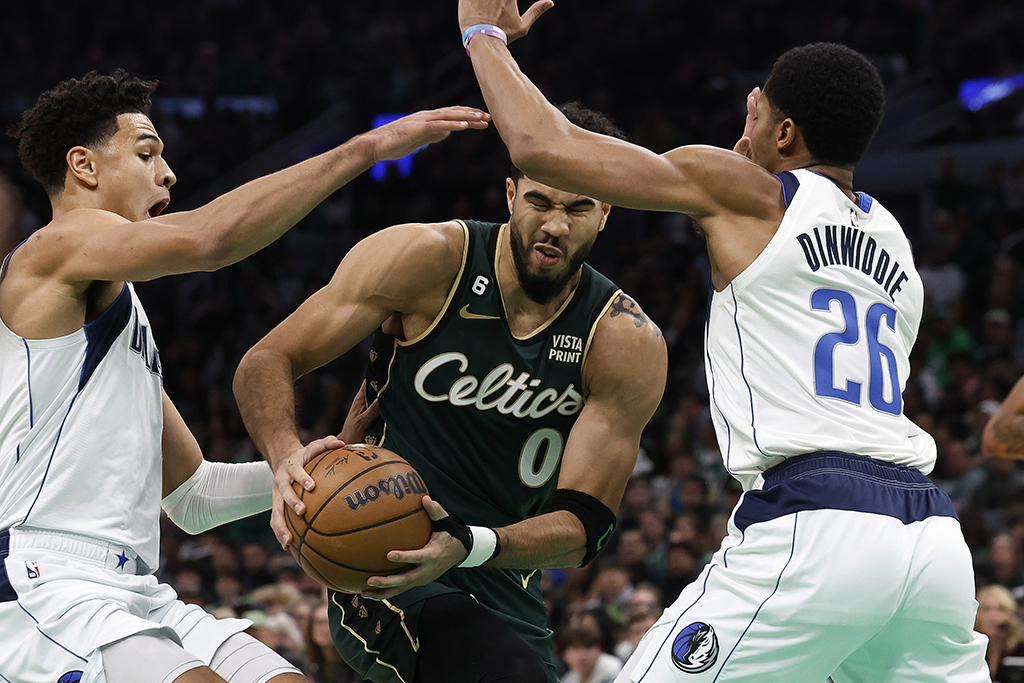 BOSTON: Jayson Tatum #0 of the Boston Celtics tries to get between Spencer Dinwiddie #26 of the Dallas Mavericks and Josh Green during the second quarter at TD Garden on November 23, 2022.- AFP