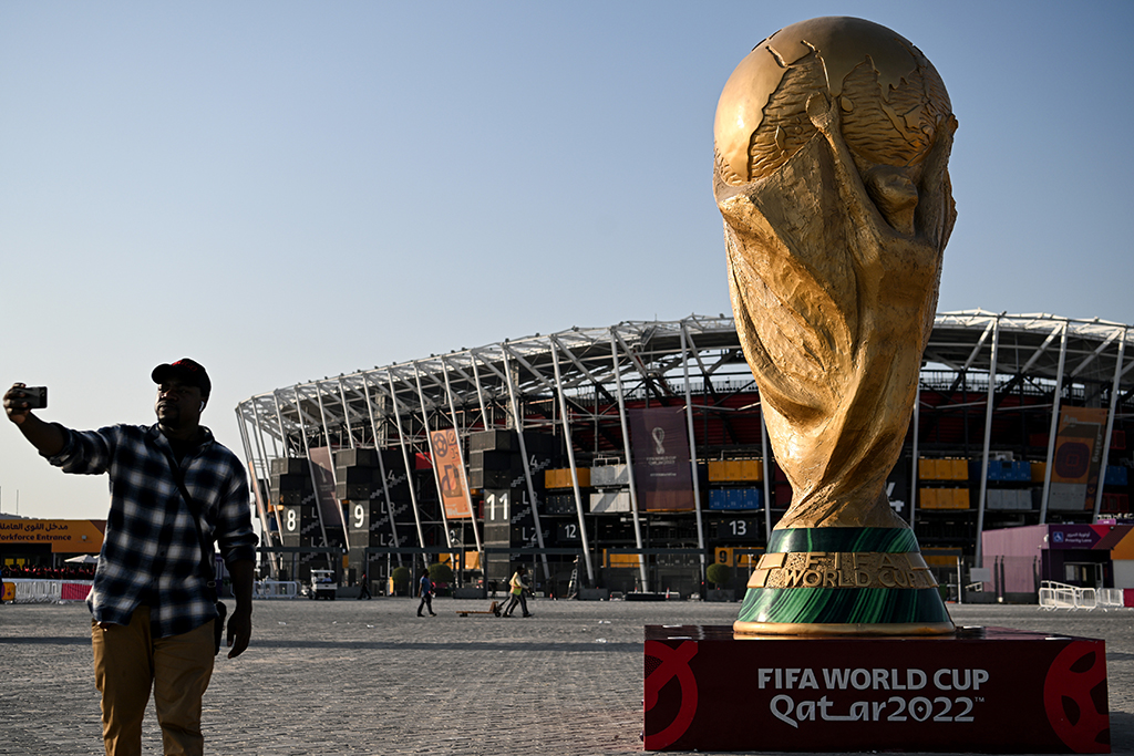 DOHA: A man takes a picture in front of a replica of the World Cup trophy outside the Stadium 974 in Doha on November 15, 2022, ahead of the Qatar 2022 World Cup football tournament. - AFP