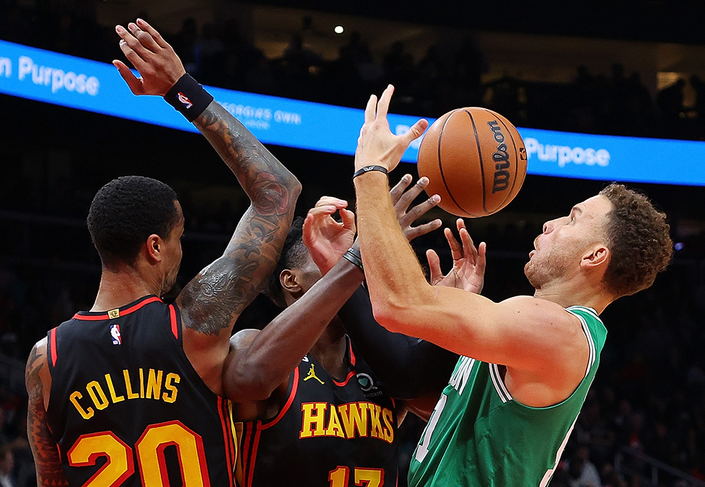 ATLANTA: Blake Griffin #91 of the Boston Celtics battles for a rebound against Onyeka Okongwu #17 and John Collins #20 of the Atlanta Hawks during the first half at State Farm Arena on November 16, 2022.- AFP