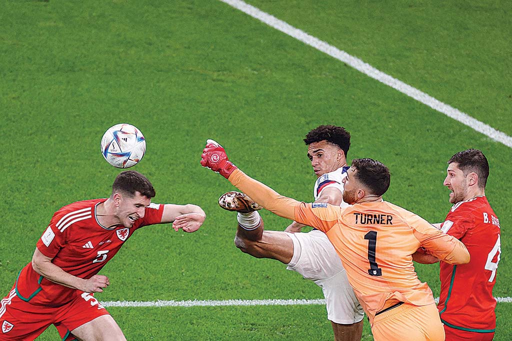 AL-RAYYAN: USA's goalkeeper #01 Matt Turner (2nd right) punches the ball ahead of Wales' defender #05 Chris Mepham (left) during the Qatar 2022 World Cup Group B football match between USA and Wales on November 21, 2022. - AFP