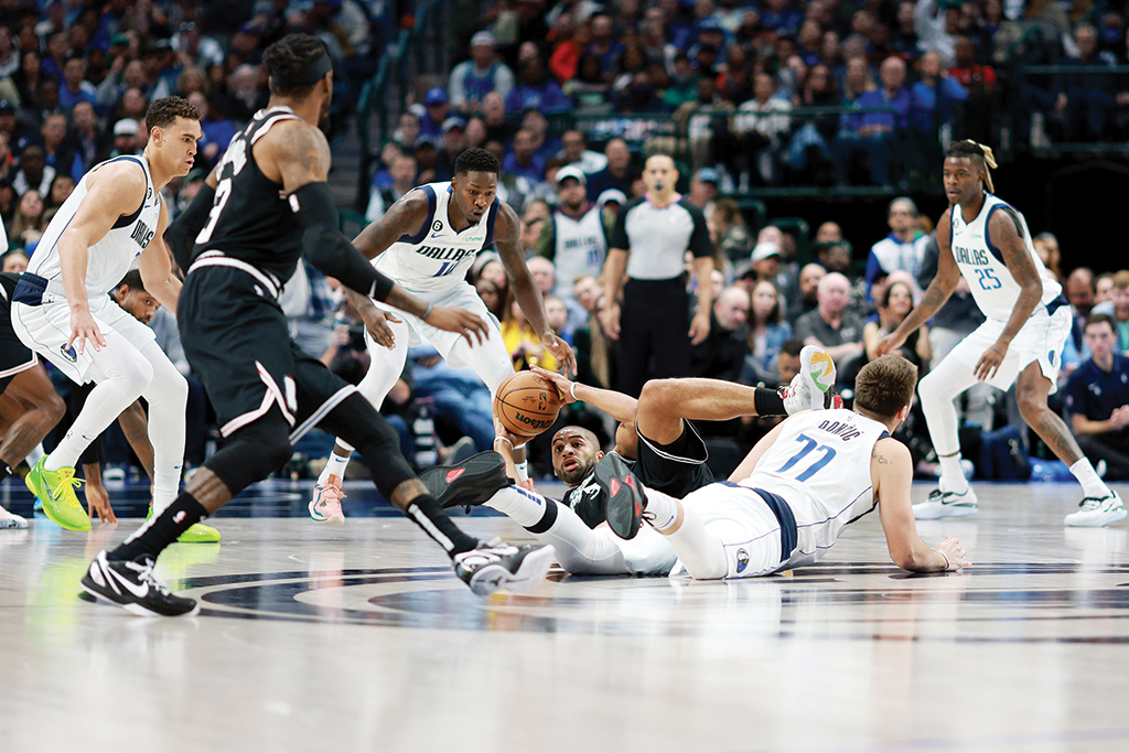 DALLAS: Nicolas Batum #33 of the LA Clippers scrambles for the ball against Luka Doncic #77 of the Dallas Mavericks in the first half at American Airlines Center on November 15, 2022.- AFP