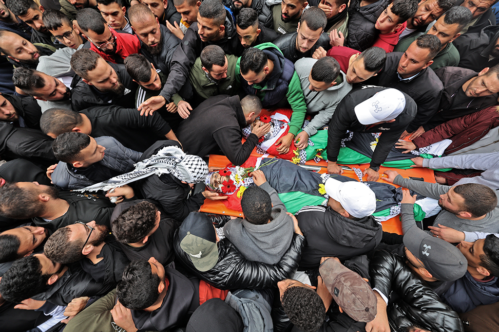 RAMALLAH: Mourners gather around the bodies of Palestinians killed by the Zionist army forces outside a morgue in the occupied West Bank on Nov 29, 2022. - AFP