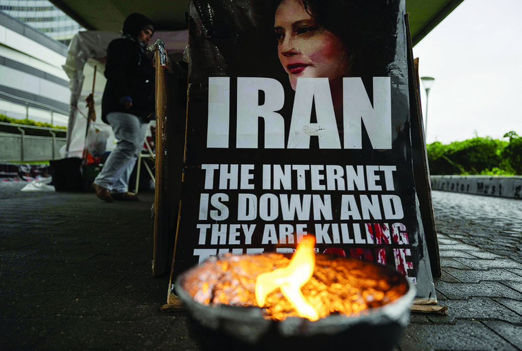 VIENNA: A placard and Iranian opposition protesters are seen outside the IAEA headquarters on Nov 16, 2022. – AFP