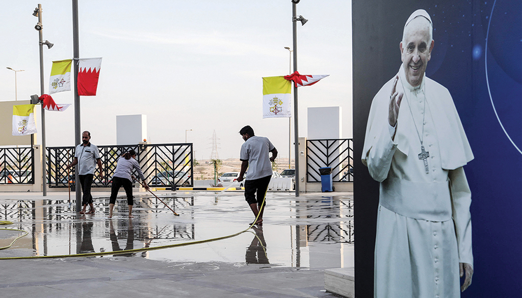 AWALI, Bahrain: Workers clean the outdoor arena in front of the Cathedral of Our Lady of Arabia on Nov 1, 2022, ahead of the Pope's visit to the kingdom. - AFP