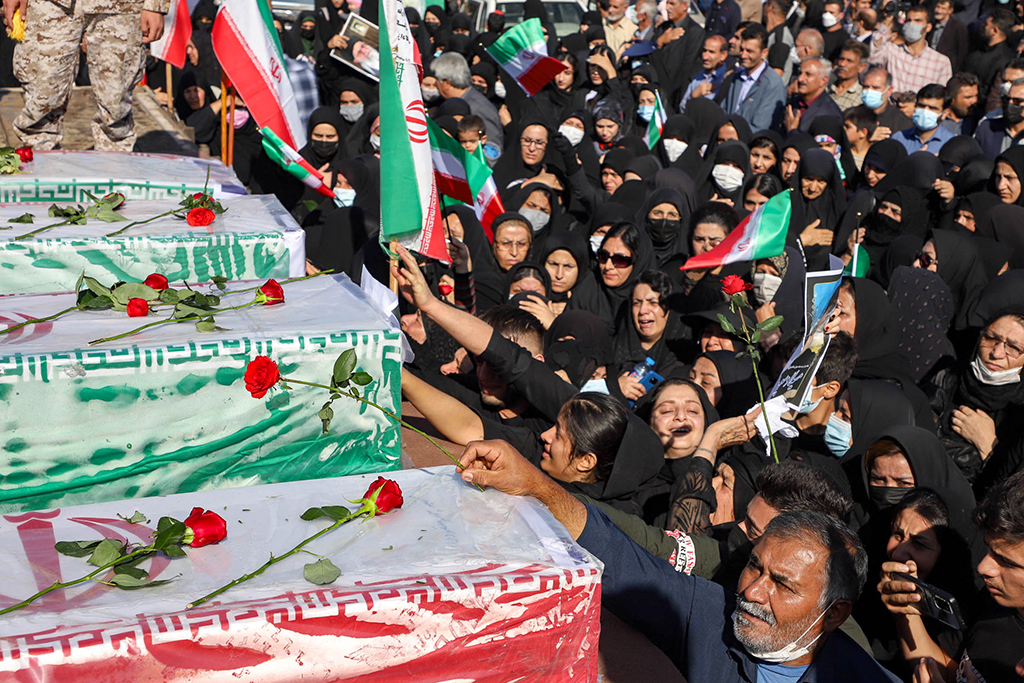 IZEH, Iran: Iranians mourn in front of the coffins of people killed in a shooting attack, during their funeral in the city of Izeh in Iran's Khuzestan province, on November 18, 2022. - AFP