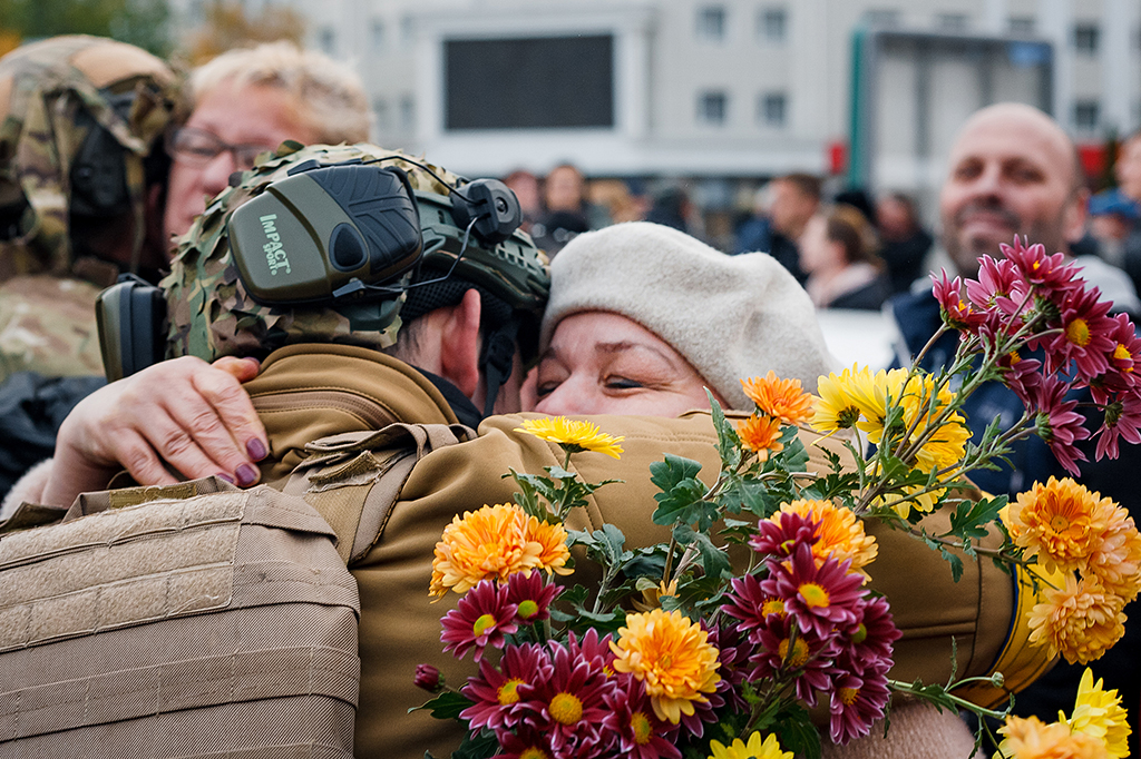 KHERSON, Ukraine: This photograph taken on November 12, 2022, shows a woman hugging a Ukrainian soldier as Ukrainians celebrate the liberation of their town in Kherson, amid Russia's invasion of Ukraine. - AFP