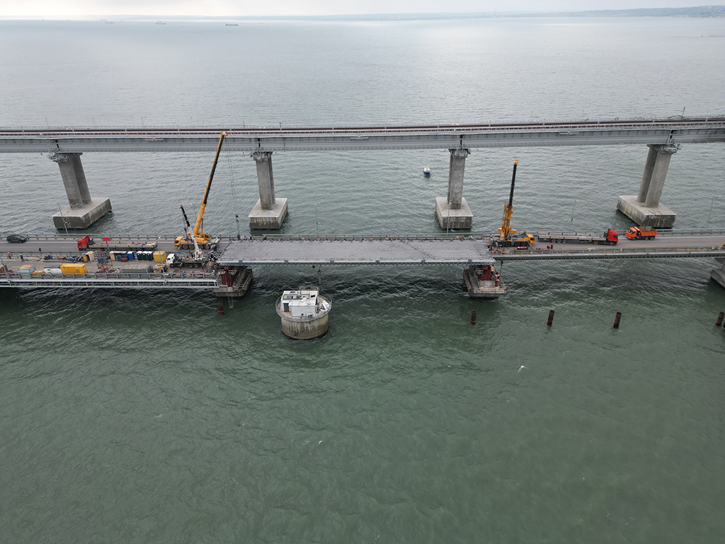 CRIMEA: This aerial picture shows restoring works on damaged parts of the Kerch Bridge that links Crimea to Russia, which was hit by a blast. - AFP