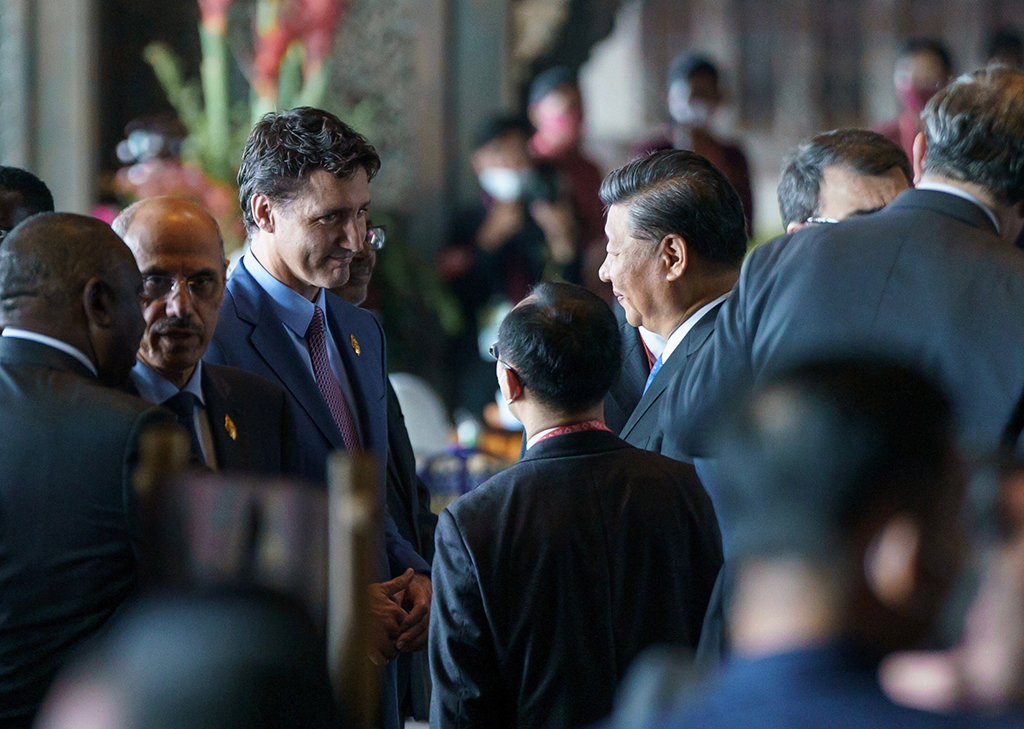 BALI: Handout photo shows Canadian Prime Minister Justin Trudeau (L) speaking to Chinese President Xi Jinping as Trudeau arrives at the G20 in Bali. - AFP