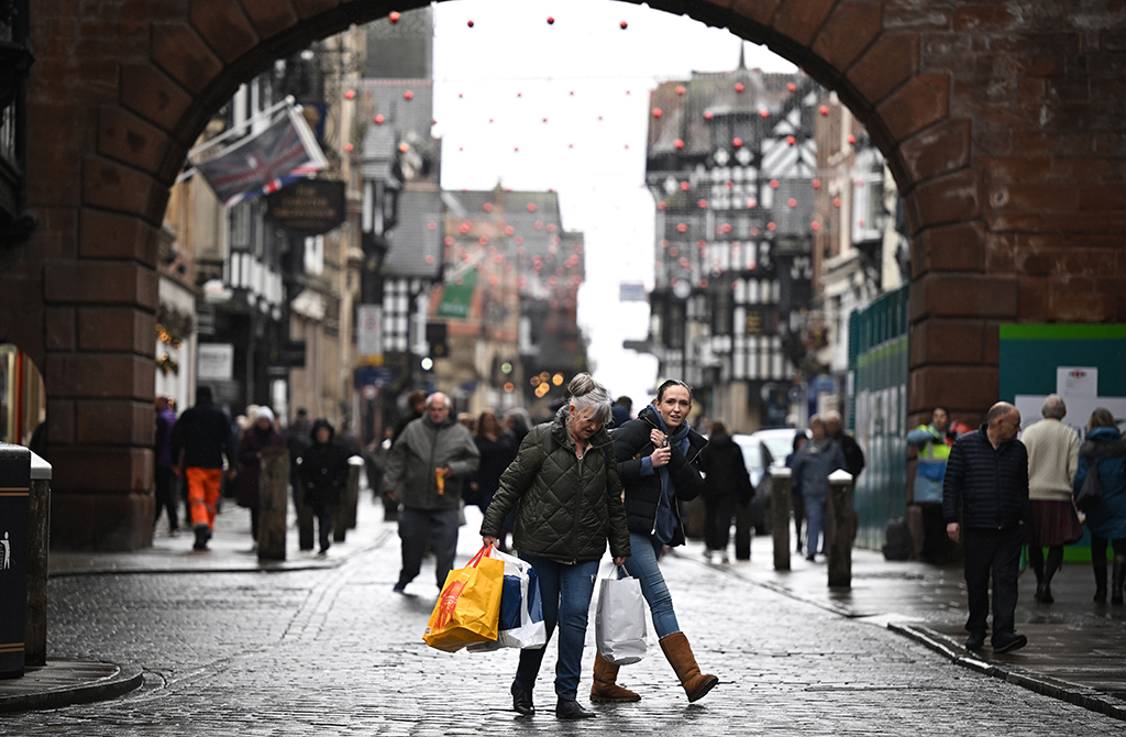 CHESTER, UK: People shop in Chester on November 17, 2022. Britain unveiled an austerity budget with £55 billion ($65 billion) of tax hikes and spending cuts despite confirming its economy was in recession. - AFP