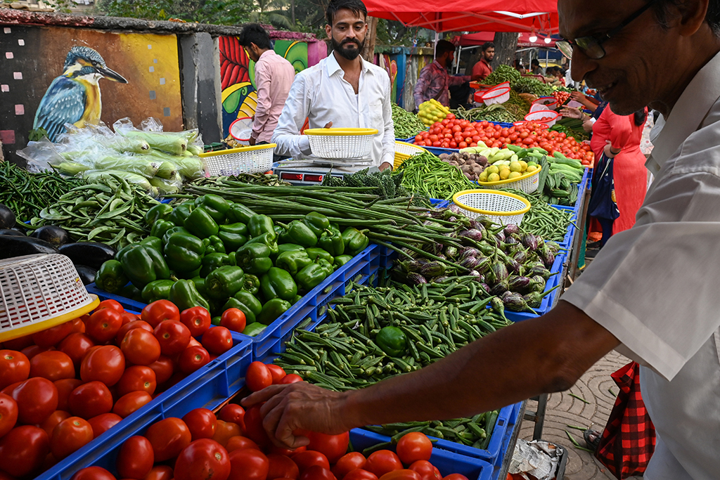 MUMBAI: A vendor arranges vegetables at a stall at a farmers market in Mumbai on November 30, 2022.-  AFP