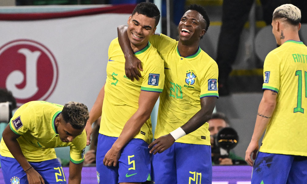 Brazil's midfielder #05 Casemiro (C) celebrates with Brazil's forward #20 Vinicius Junior after he scored his team's first goal during the Qatar 2022 World Cup