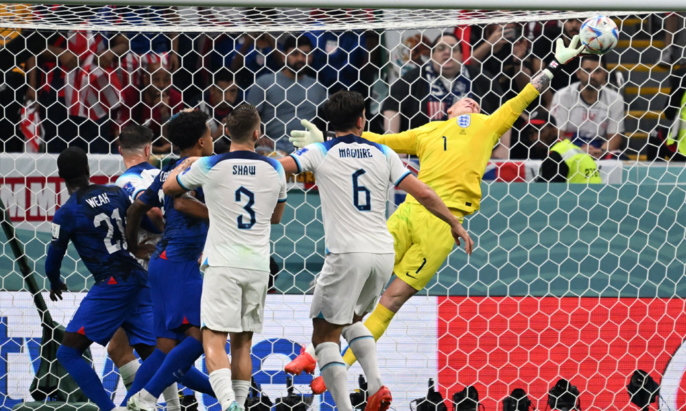 England's goalkeeper #01 Jordan Pickford dives to make a save during the Qatar 2022 World Cup