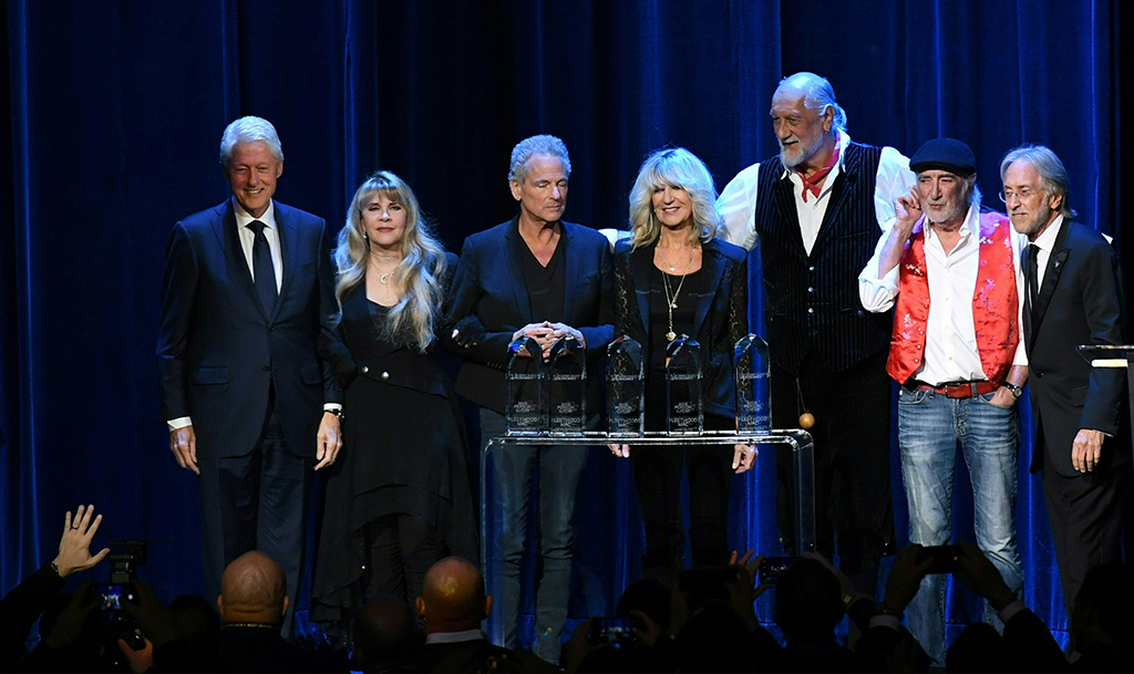 In this file photo (from left) former US president Bill Clinton, Stevie Nicks, Lindsey Buckingham, Christine McVie, Mick Fleetwood, John McVie and Recording Academy president Neil Partnow pose on stage at the 2018 MusiCares Person Of The Year gala at Radio City Music Hall in New York.—AFP photos