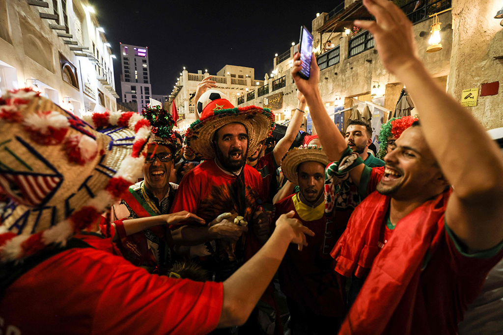 Morocco’s supporters celebrate their team’s qualification for the next round of the Qatar 2022 World Cup after their victory in the Group F football match against Canada in the Souq Waqif marketplace in Doha.— AFP photos 