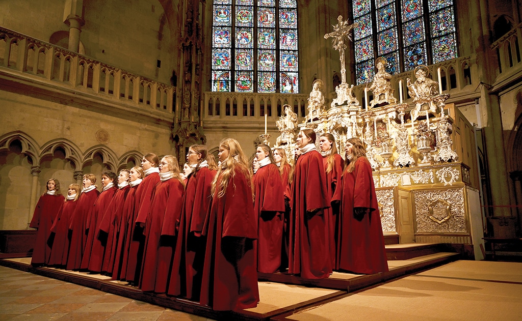 Members of the Regensburger Domspatzen girls' choir sing during their first appearance during a service at the Regensburg Cathedral.