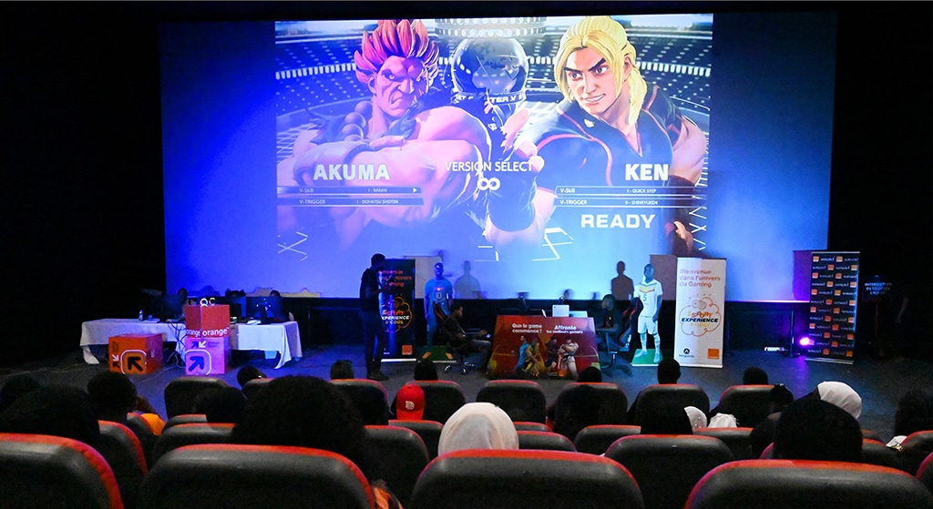 People follow a video game fighting match projected on the big screen in a cinema in Dakar.—AFP photos 