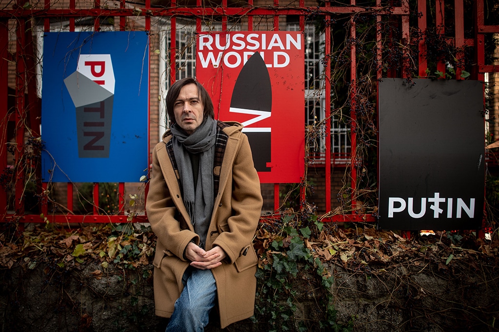 BRATISLAVA: Ukrainian graphic designer Mykola Kovalenko poses during a photo session in front of his posters in downtown Bratislava, Slovakia on November 29, 2022. The award-winning artist, who has lived in Slovakia since 2015, said he initially wanted to take up arms against Russia. - AFP