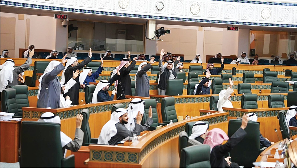 KUWAIT: MPs raise their hands to approve the housing law at the National Assembly on Wednesday. - Photo by Fouad Al-Shaikh