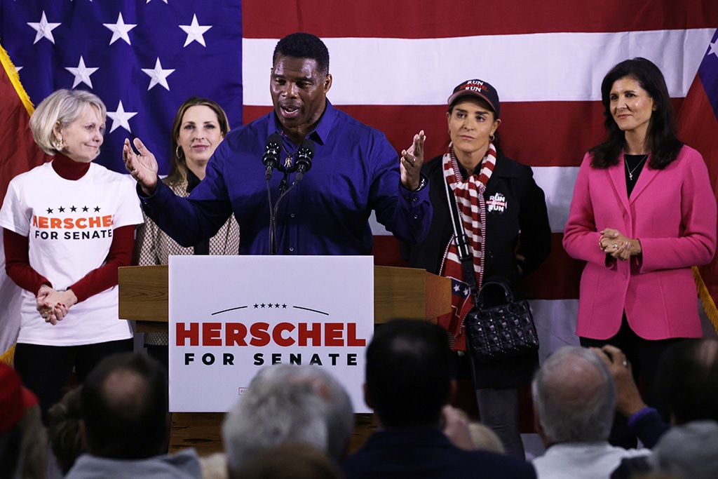 KENNESAW: Georgia Republican Senate candidate Herschel Walker speaks as (left to right) Republican National Committeewoman for Georgia Ginger Howard, Republican National Committee Chair Ronna McDaniel, Walker’s wife Julie Blanchard and former US Ambassador to the UN Nikki Haley listen during a campaign rally in Kennesaw, Georgia. – AFP