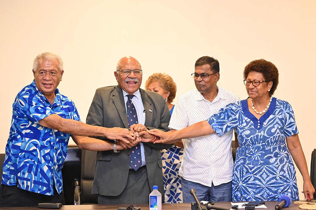 SUVA: People's Alliance Party leader Sitiveni Rabuka (2nd L) joins hands with the coalition partners, Biman Prasad (2nd R), Party leader of the National Federation Party, and Anare Jalu (L) , Chair of the Social Democratic Liberal Party (SODELPA), after an agreement to form a new government in Suva. - AFP