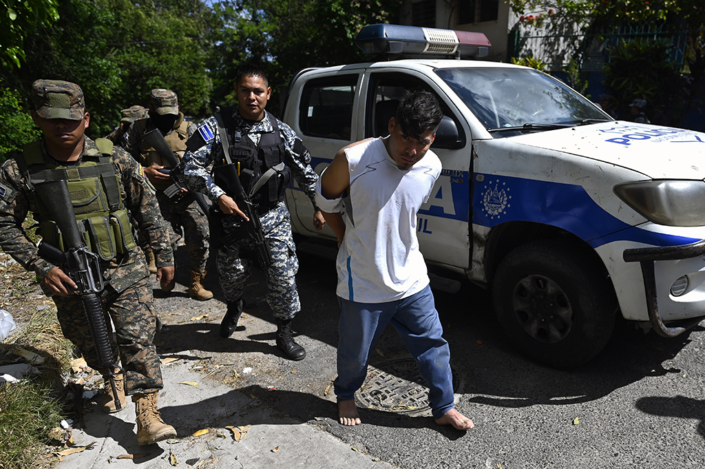 SOYAPANGO, El Salvador: Police and soldiers escort people captured during an operation against gang members in Soyapango, El Salvador. - AFP