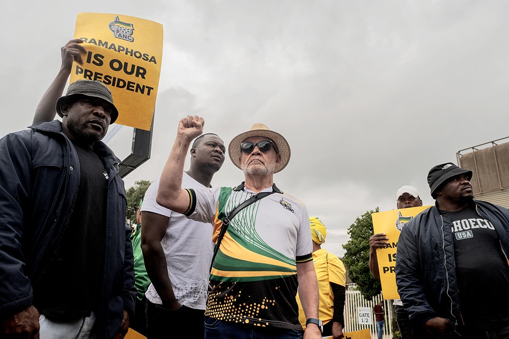 JOHANNESBURG, South Africa: Carl Niehaus (C), veteran member of the African National Congress (ANC) gestures as he expresses his views on South African President Cyril Ramaphosa outside the NASREC Centre in Johannesburg. – AFP