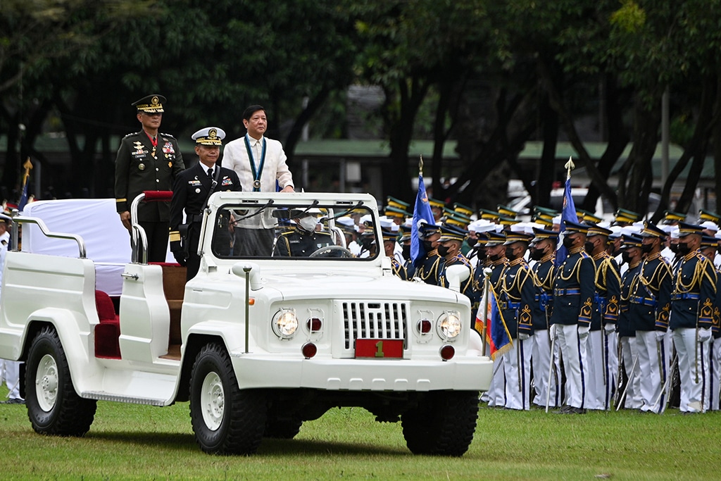 QUEZON CITY: Philippine President Ferdinand Marcos Jr (C) rides a military vehicle as he inspects the troops during the 87th anniversary celebration of the Armed Forces of the Philippines. – AFP