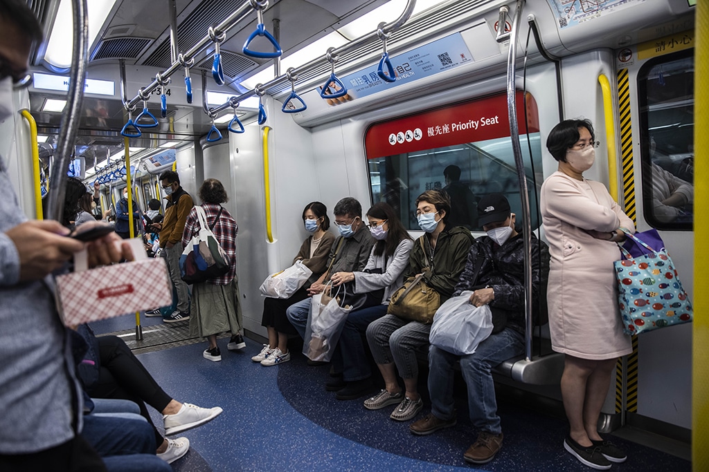 HONG KONG, China: People wear masks as they ride the mass transit rail (MTR) in Hong Kong on December 8, 2022. – AFP