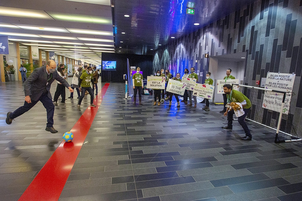 MONTREAL: Conference participants play soccer as climate activists hold signs during the United the Nations Biodiversity Conference (COP15) in Montreal, Quebec, Canada, on December 16, 2022. – AFP