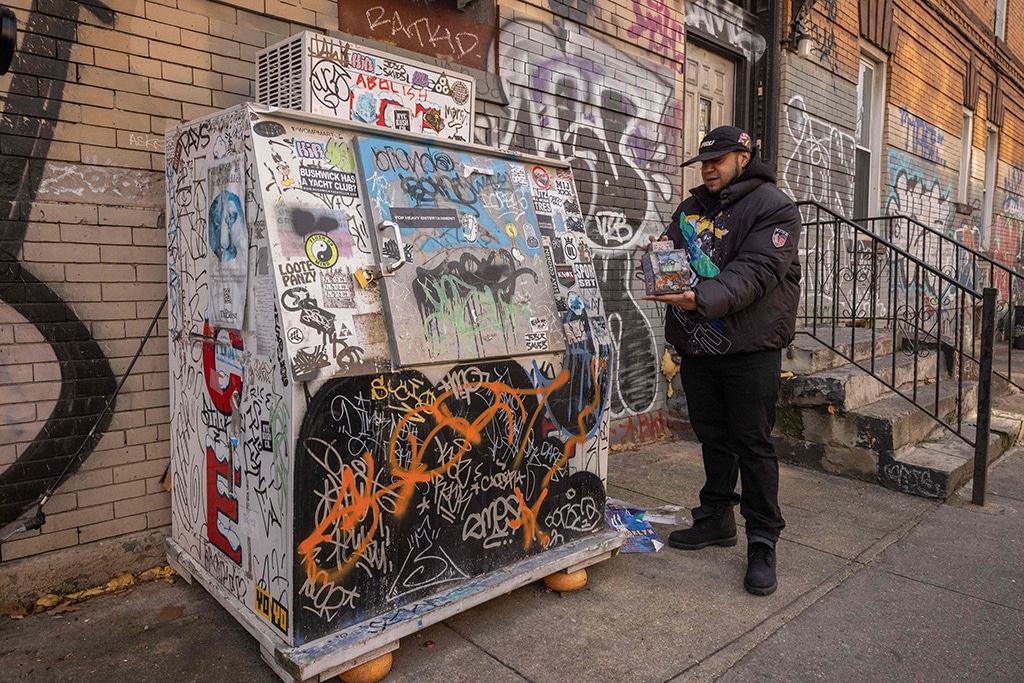 Danny Cortes, a street miniature artist, shows his miniature of an icebox in the Brooklyn borough of New York City on Dec 19, 2022. – AFP photos