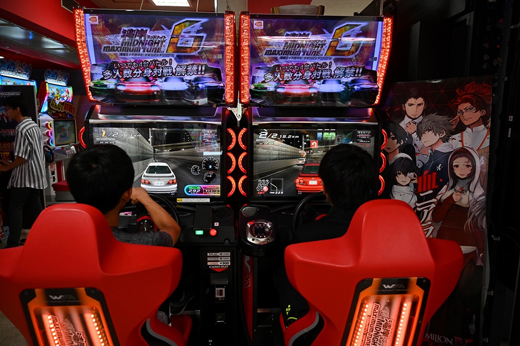 OITA, Japan: In this file photo, children play a video game in Oita. From Super Mario to Final Fantasy, Japan has long been synonymous with gaming, but some experts and parents fear a growing addiction problem is going unaddressed. -- AFP