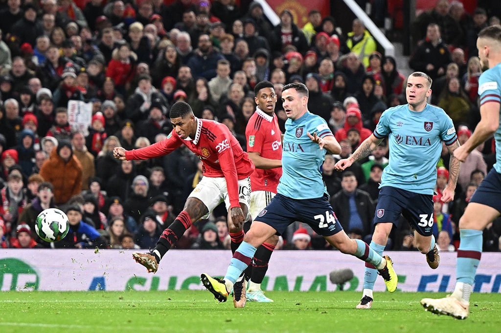 MANCHESTER: Manchester United’s English striker Marcus Rashford (left) shoots and scores his team second goal during the English League Cup fourth round football match between Manchester United and Burnley, at Old Trafford on December 21, 2022. – AFP