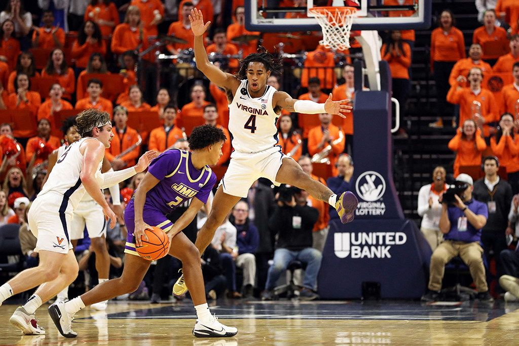 CHARLOTTESVILLE: Armaan Franklin #4 of the Virginia Cavaliers defends Tyree Ihenacho #2 of the James Madison Dukes in the second half during a game on December 6, 2022.- AFP