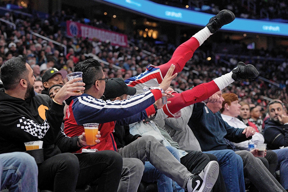 WASHINGTON: Kyrie Irving #11 of the Brooklyn Nets falls into fans on the sidelines during the second half of the game at Capital One Arena in Washington, DC. - AFP