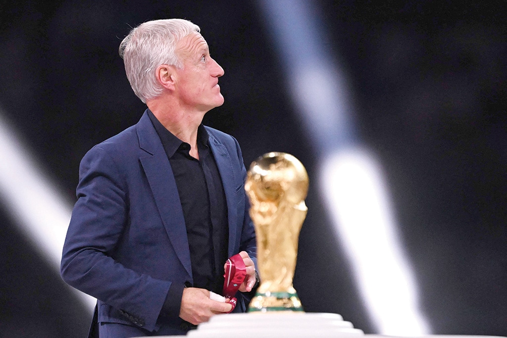 DOHA: France's coach Didier Deschamps looks away as he walks past the FIFA World Cup trophy during the trophy ceremony after France lost the Qatar 2022 World Cup final football match between Argentina on December 18, 2022.- AFP