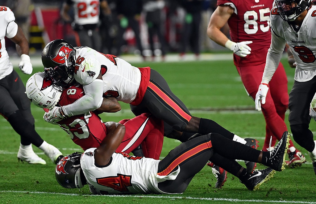 GLENDALE: Greg Dortch #83 of the Arizona Cardinals is hit by Devin White #45 and Lavonte David #54 of the Tampa Bay Buccaneers after making a catch during the 2nd half of the game at State Farm Stadium on December 25, 2022.- AFP