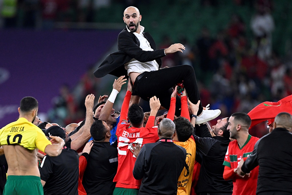 DOHA: Morocco's players carry their coach Walid Regragui as they celebrate after winning the Qatar 2022 World Cup quarter-final football match between Morocco and Portugal at the Al-Thumama Stadium in Doha.- AFP