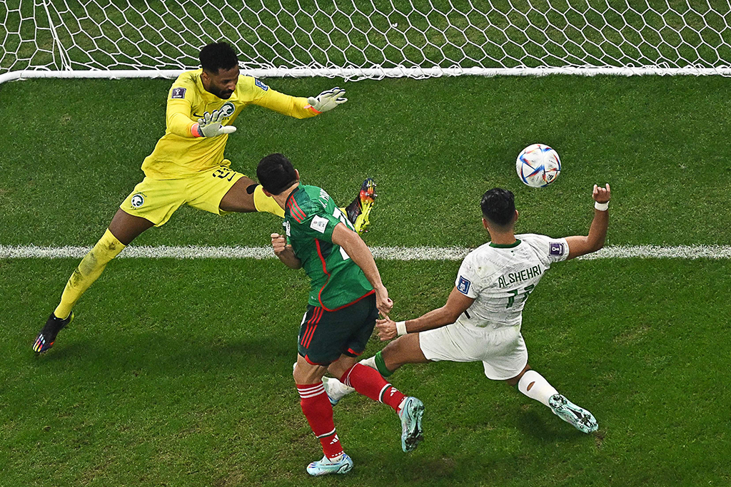 DOHA: Mexico’s forward #20 Henry Martin (center) scores his team’s first goal past Saudi Arabia’s goalkeeper #21 Mohammed Al-Owais during the Qatar 2022 World Cup Group C football match between Saudi Arabia and Mexico on November 30, 2022. – AFP