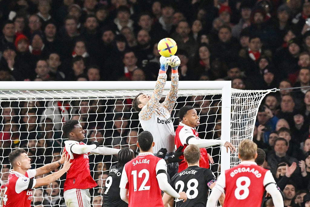 LONDON: West Ham United’s Polish goalkeeper Lukasz Fabianski jumps to stop the ball during the English Premier League football match between Arsenal and West Ham United at the Emirates Stadium in London on December 26, 2022. – AFP