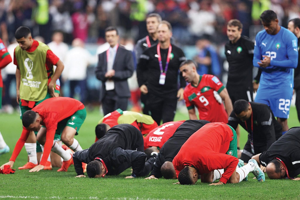 DOHA: Morocco’s players pray and thank the crowd after losing 2-0 in the Qatar 2022 World Cup semi-final match against France at the Al-Bayt Stadium in Al Khor on Dec 14, 2022. — AFP