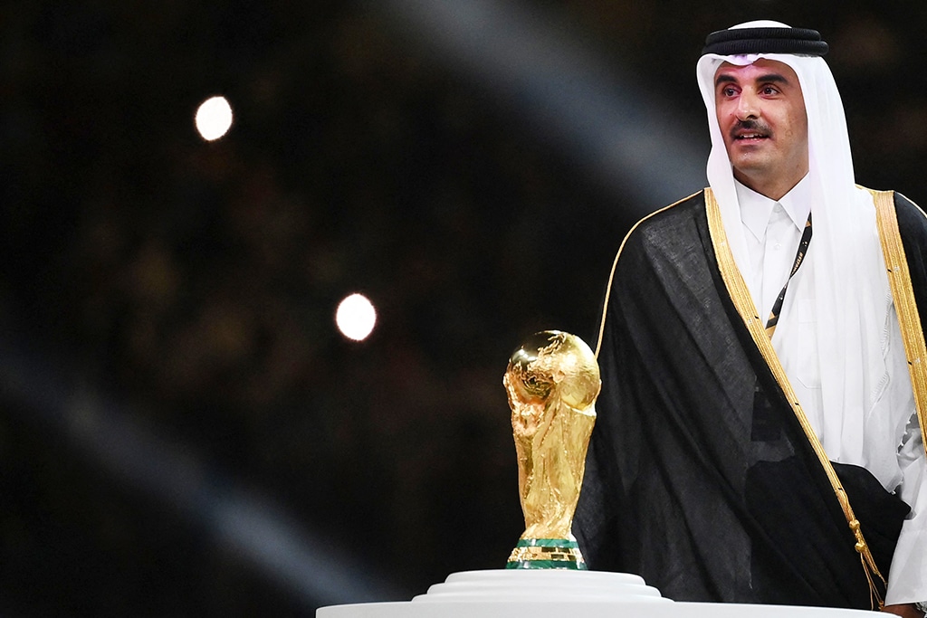 DOHA: Qatar's Amir Sheikh Tamim bin Hamad Al-Thani stands next to the World Cup trophy during the award ceremony after the final match between Argentina and France at Lusail Stadium on Dec 18, 2022. - AFP