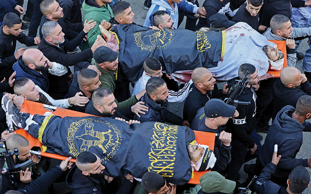 JENIN: Palestinian mourners carry the bodies of Naim Jamal Zubaidi, 27, and Muhammad Ayman Al-Saadi, 26, during their funeral procession in the occupied West Bank on Dec 1, 2022. - AFP