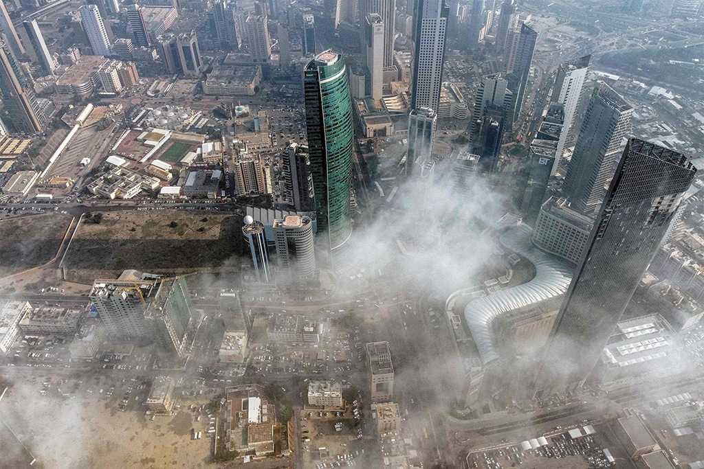 KUWAIT: This aerial view shows mist covering skyscrapers in the center of Kuwait City on Dec 28, 2022. — Photo by Yasser Al-Zayyat