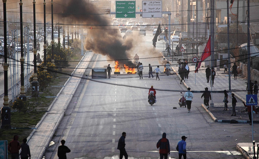 NASIRIYAH, Iraq: Iraqi demonstrators block a road with burning tyres as they protest the death of fellow protestors in clashes with security forces in this southern city on Dec 11, 2022. - AFP