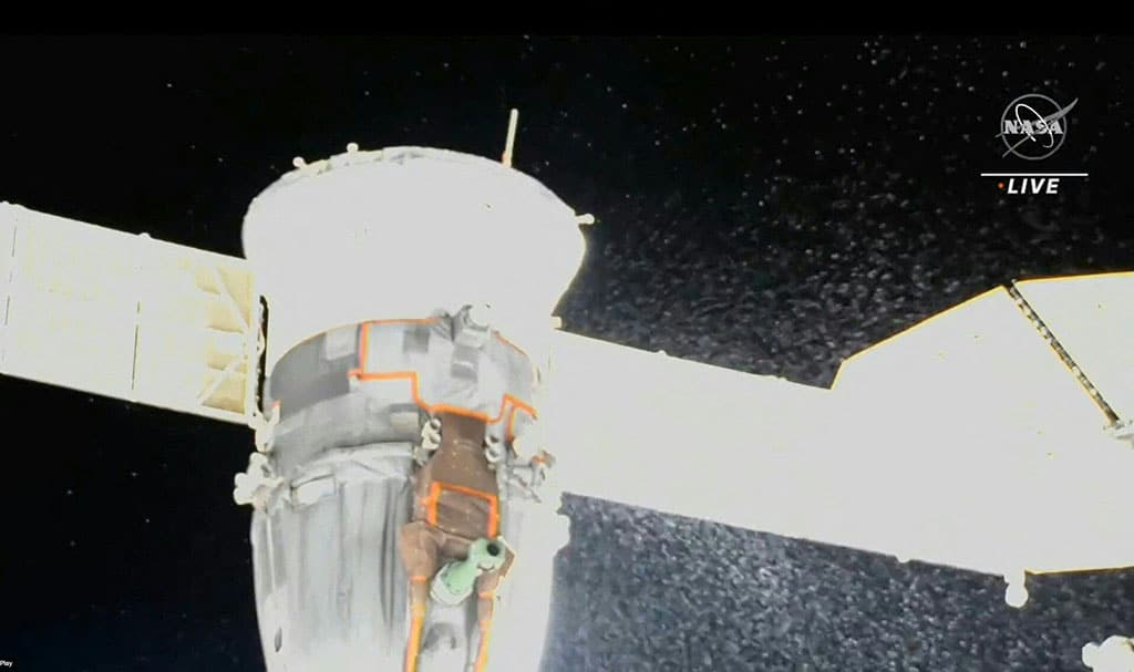 Video grab from a NASA feed obtained Dec 15, 2022 shows liquid spraying from the aft end of the Soyuz MS-22 spacecraft. – AFP