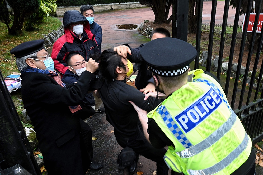 MANCHESTER: Photo shows an incident involving a scuffle between a Hong Kong pro-democracy protester (center) and Chinese consulate staff, as a British police officer attempts to intervene, during a demonstration outside the consulate in Manchester. – AFP